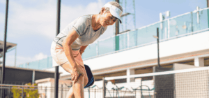 Elderly person struggling with leg cramp and muscle spasms